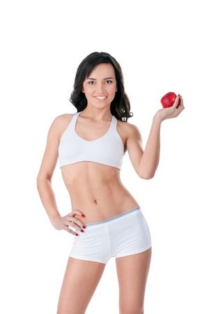 Yound fit girl  holding red apple and smilingの写真素材