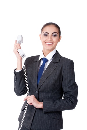 Young businesswoman speaking on phone, smiling, isolated on whiteの写真素材