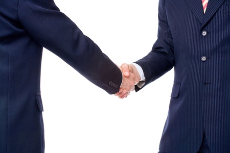 Two businessmen in formal suits shaking handsの写真素材