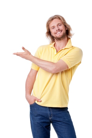 Handsome young man presenting, pointing to copyspaceの写真素材