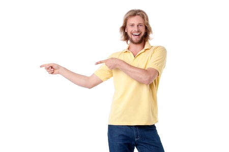 Handsome young man presenting, pointing to copyspaceの写真素材