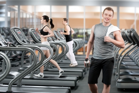 Young man relaxing after running in fitness clubの写真素材