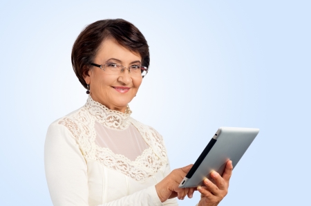 Portrait of success senior woman with digital tablet looking at youの写真素材