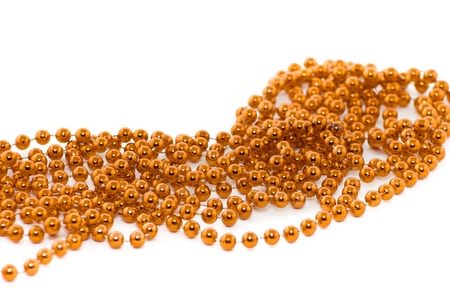 Background of gold  christmas beads isolated on whiteの写真素材