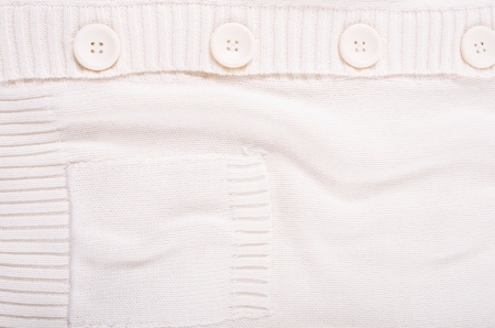 Knitted white jersey texture with a buttonの写真素材