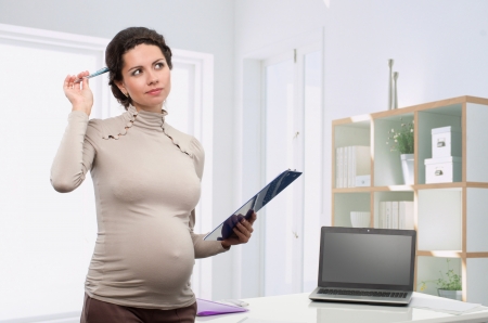 pregnant business woman in the officeの写真素材