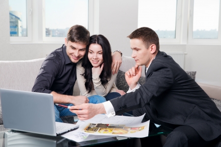 couple is considering the future design of the apartment with a designerの写真素材