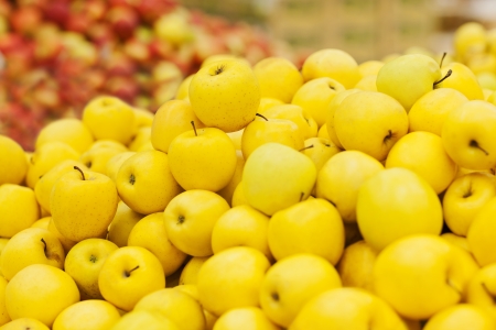 yellow apple on the shelf in the supermarketの写真素材
