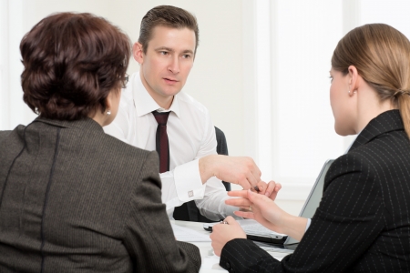 Agent  or notary public  signing documents with senior woman and her daughterの写真素材