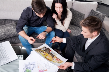 couple is considering the future design of the apartment with a designer, top viewの写真素材