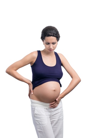young pregnant woman with stomach pain isolated on white backgroundの写真素材