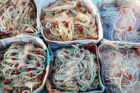 texture of fishnets on fish boat folded in boxes