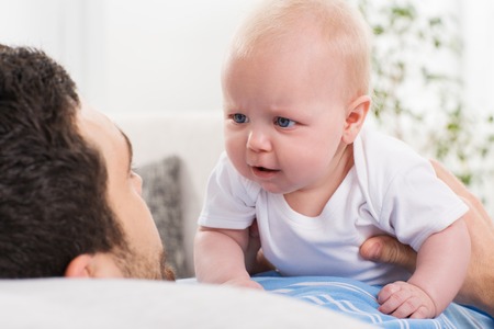 young father cannot soothe his little baby