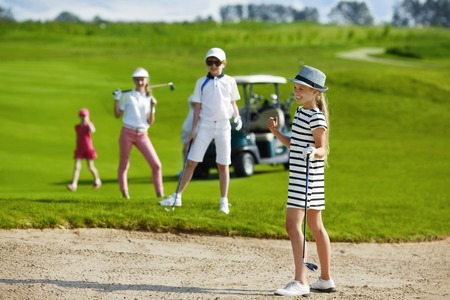 Girl playing golf and  enjoing on the successful hitの写真素材