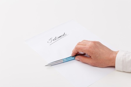Hands of elderly woman writing ot paper testamentの写真素材