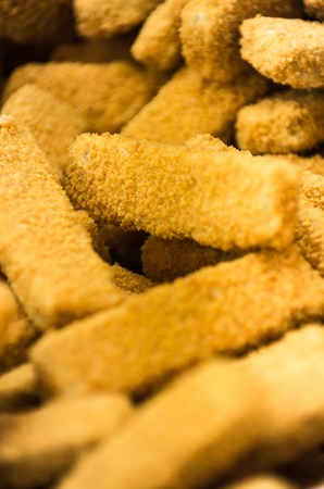 A pile of beautiful crab sticks on a counter in supermarket