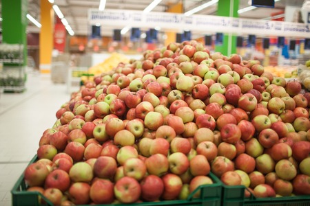 Red apples on the shelf in the supermarketの写真素材