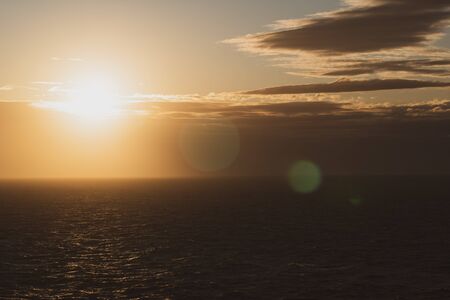 Beautiful sunrise over the sea, orange color filtered effectの写真素材