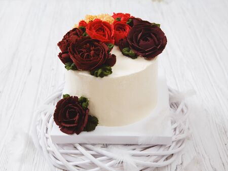 Naked wedding birthday cake. Rustic layer homemade cake with cream. Dessert decorated with roses flower. Piece of cake. Vegan raw cake. holiday conceptの写真素材
