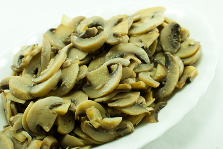 White oval plate filled with gold brown fried mushrooms. Isolatedの写真素材