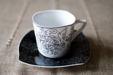 Empty white cup on a black saucer; vintage designの写真素材