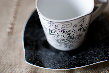Empty white cup on a black saucer; vintage designの写真素材