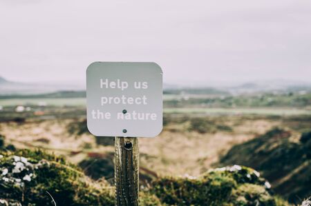 A sign Help us protect the nature on the territory of a National Park in Iceland. Concept of...