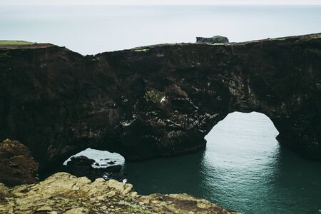 Dyrholaey, a rocky arch in the cliff. A magical place in Iceland.の写真素材