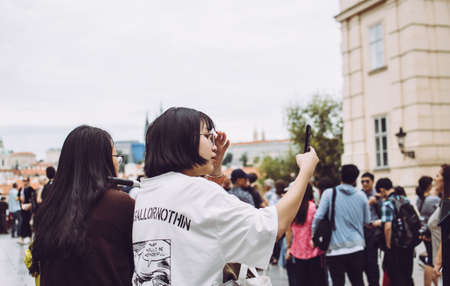 Prague, Czech Republic - August 17, 2019: Two young asian girls taking a selfie in the central part of the cityのeditorial素材
