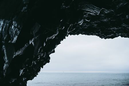 View from the cave on Reynisfjara beach in Iceland. Cold Atlantic oceanの写真素材