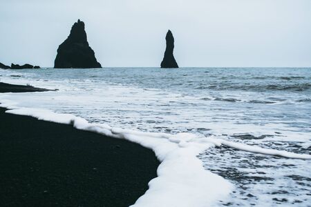 Famous view on Reynisfjara beach in Iceland. Black sand and white foamの写真素材