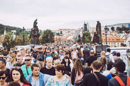 Prague, Czech Republic - August 17, 2019: Hundreds of tourists crossing a famous Charles Bridge.のeditorial素材