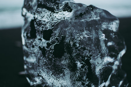 Close-up of glacier covered with black soil. Transparent blue ice.の写真素材