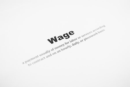 Closeup of a typed definition of the word wage. Paper sheetの写真素材
