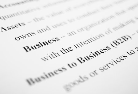 Closeup of popular business-related terms and their respective definitions on the white paper.の写真素材