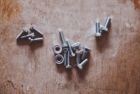 New bolts laying on the wooden floor. Dirty old garageの写真素材