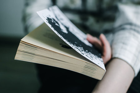 Depressed girl holding a book on psychology