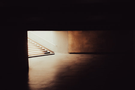 Melancholic urban background of an empty underground pedestrian crossing and a bright light at the...
