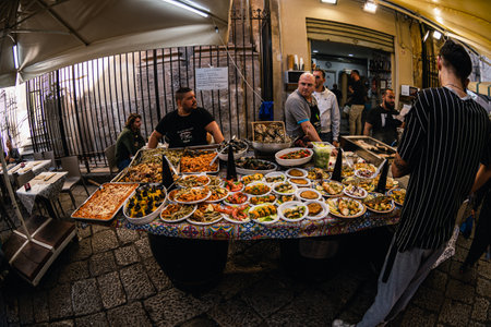 Palermo, Italy - November 4, 2023: Seafood sold on a local market in sicily. Heaps of products lying on counters.のeditorial素材