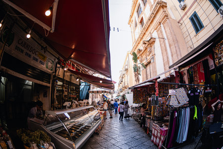 Palermo, Italy - November 4, 2023: Tourists walking  in a local market, looking around and buying products from locals.のeditorial素材