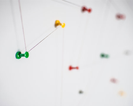Background. Abstract concept (idea) of network, social media, internet, teamwork,  communication abstract. Colorful push pins linked together by red thread. Isolated. Entities connected.の写真素材