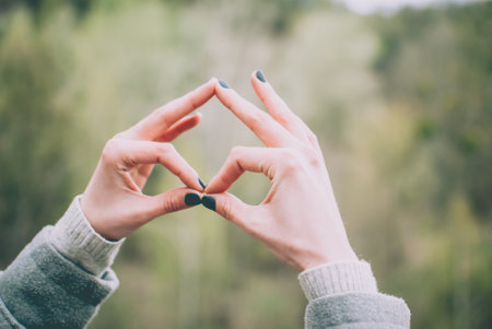Tender girl's pale hands forming a gesture. Concept (idea).の写真素材