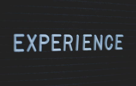 Word experience written on the letter board. White letters on the black background. Business conceptの写真素材