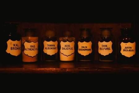 Multiple pharmaceutical liquids on a shelf in an old pharmacy basement
