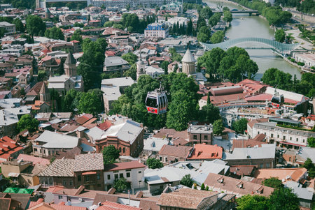 Panoramic view of Old Tbilisi, the capital of Georgia. Cable car over the city. Hot sunny afternoon....