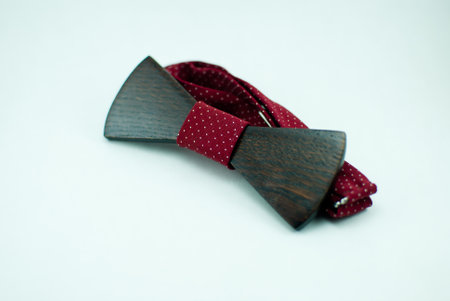 Stylish wooden bowtie with red soft cloth ribbon. Isolatedの写真素材
