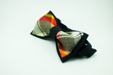 Well-designed stylish black-green-yellow-white bow tie made of soft clothの写真素材
