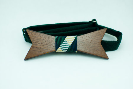 Stylish wooden bowtie with green soft cloth ribbon. Isolatedの写真素材