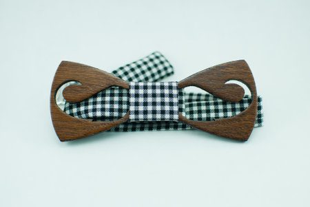 Stylish wooden bowtie with white and black soft cloth ribbon. Isolatedの写真素材