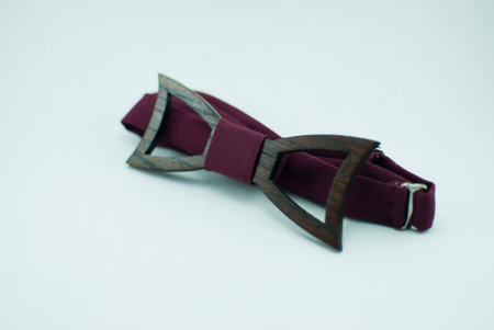 Stylish wooden bowtie with red soft cloth ribbon. Isolatedの写真素材